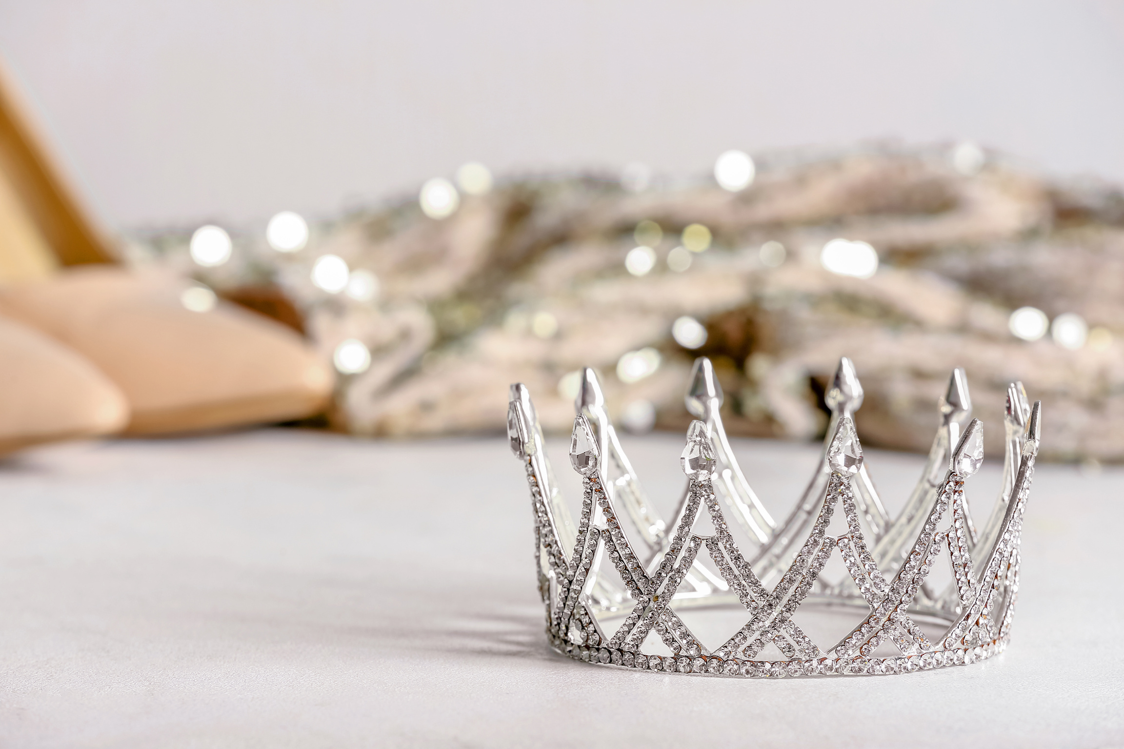 Beautiful Crown on White Table, Closeup. Prom Concept