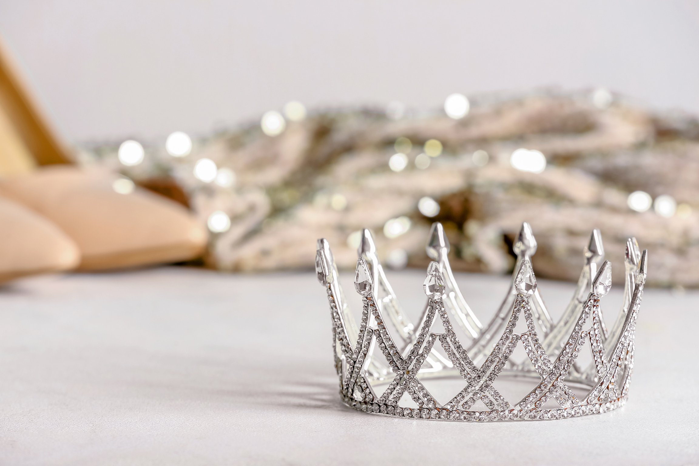 Beautiful Crown on White Table, Closeup. Prom Concept